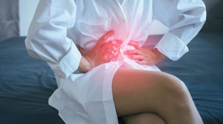 a woman experiencing pain in her stomach