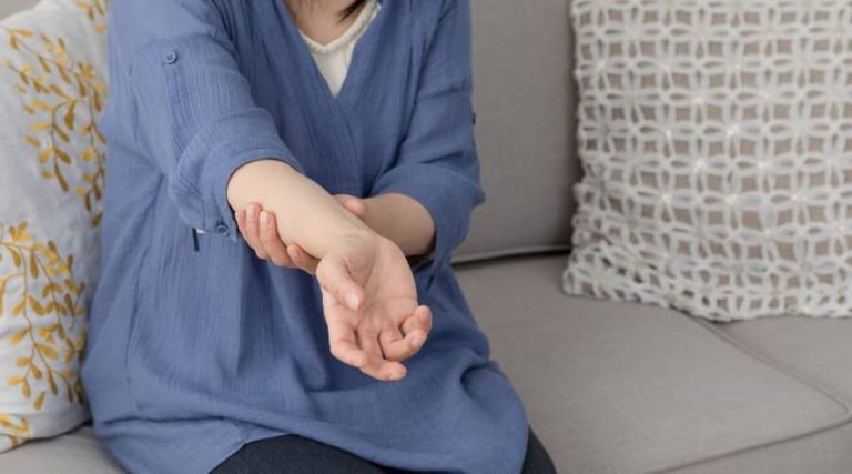 A lady experiencing arm pain at night