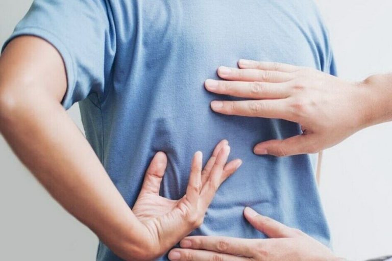 A man is trying to treat a pinched back with the help of other