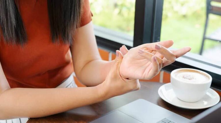 woman applying anti-inflammatory cream on her wrist