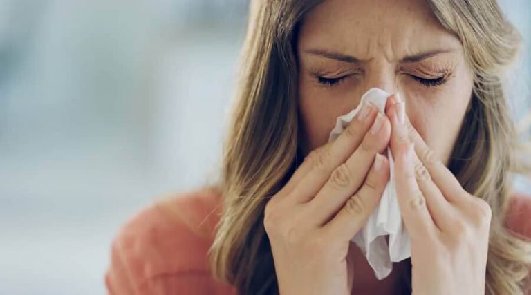 a girl who sneezing experiencing nasal congestion