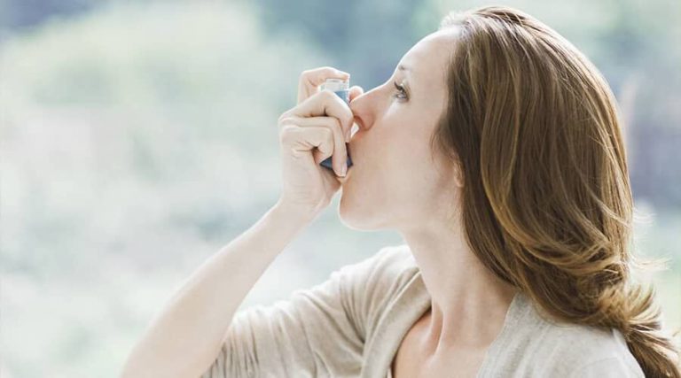 Women Using asthma inhaler