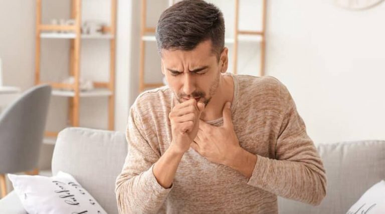 A men coughing and experiencing symptoms of acute bronchitis