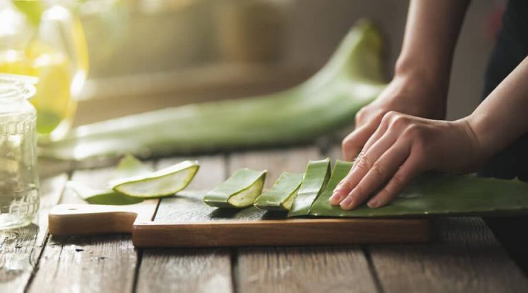 A person were chopped aloe vera on a wooden board