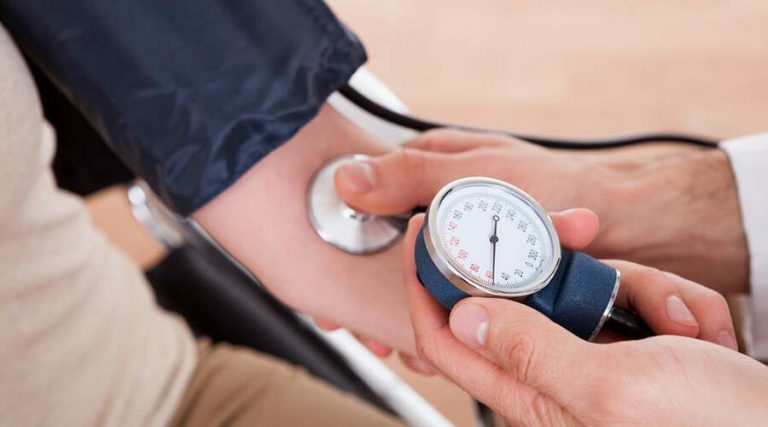 A doctor is measuring blood pressure of a person