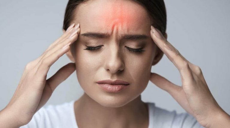 A women holding her head is suffered from serve headache