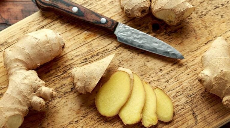 "Knife and ginger placed on a surface