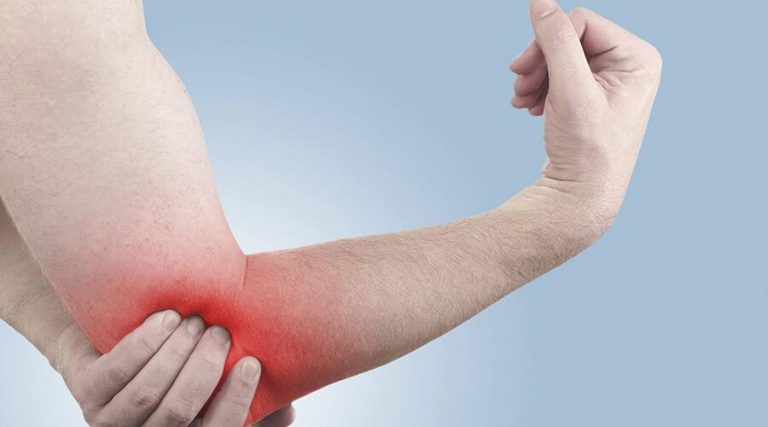 a man touching his elbow in pain
