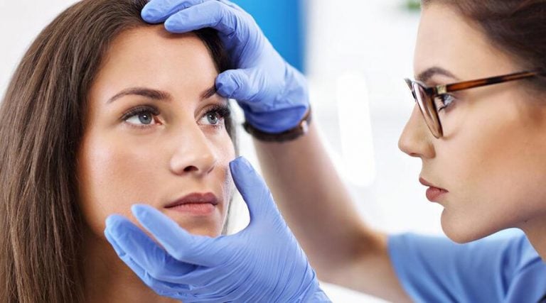 doctor checking eye of a young woman