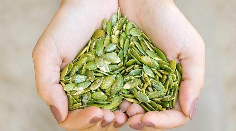 hands full of pumpkin seeds