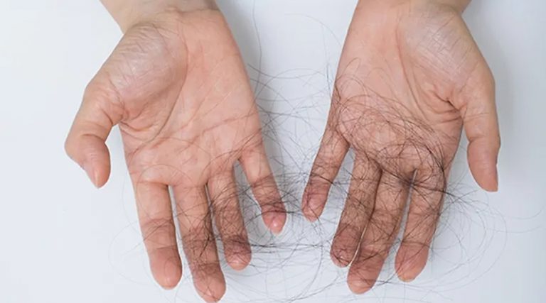 a hand full of broken hair with white background