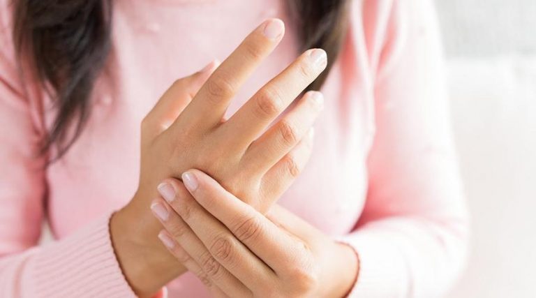 a women pressing her palm with her fingers